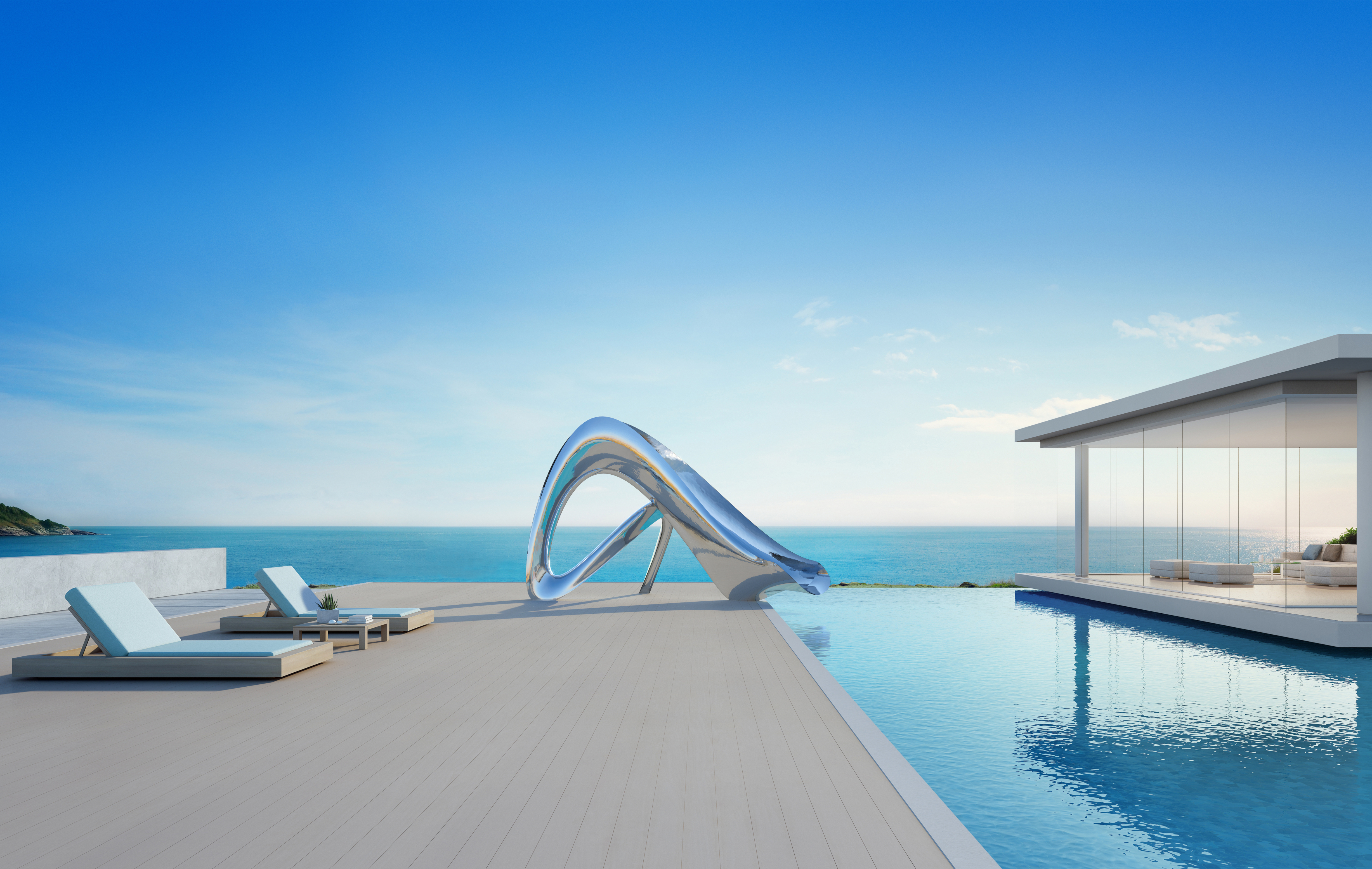 Sculptural pool side slide next to ocean view pool and modern house