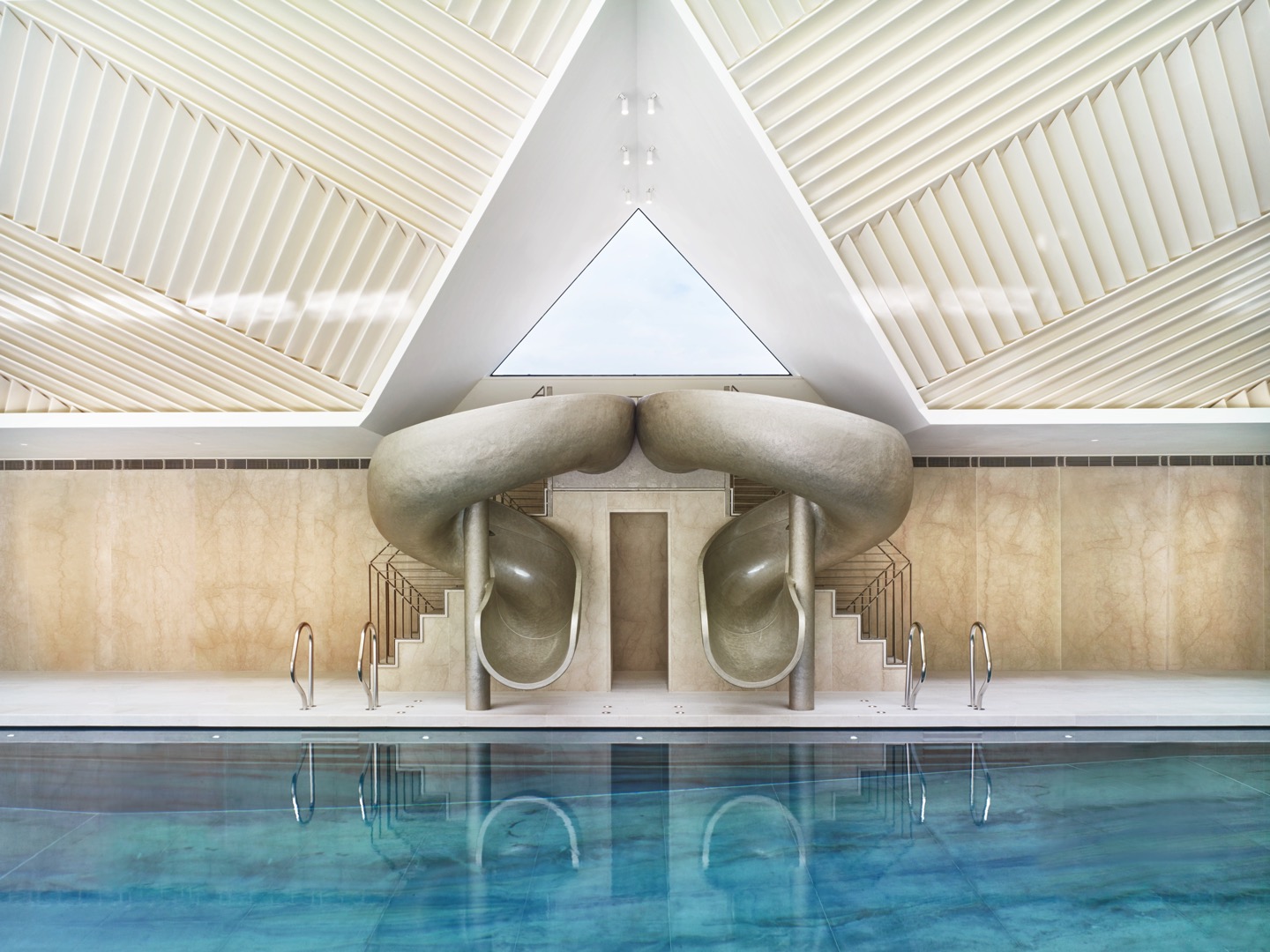 Double pool slide by Splinterworks in spectacularly designed pool pavilion.