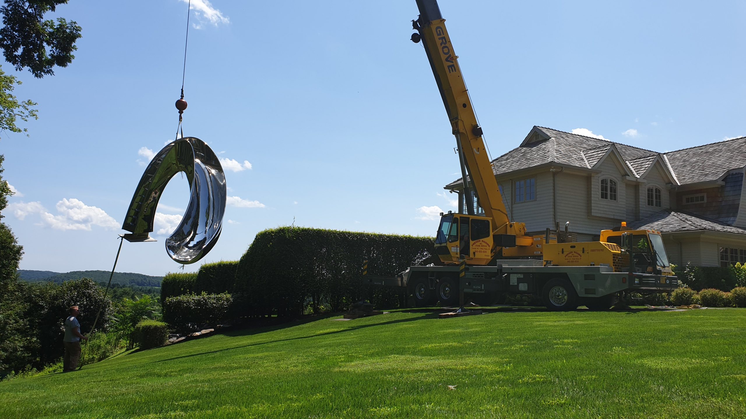 Craning in huge sculptural pool slide for outdoor pool