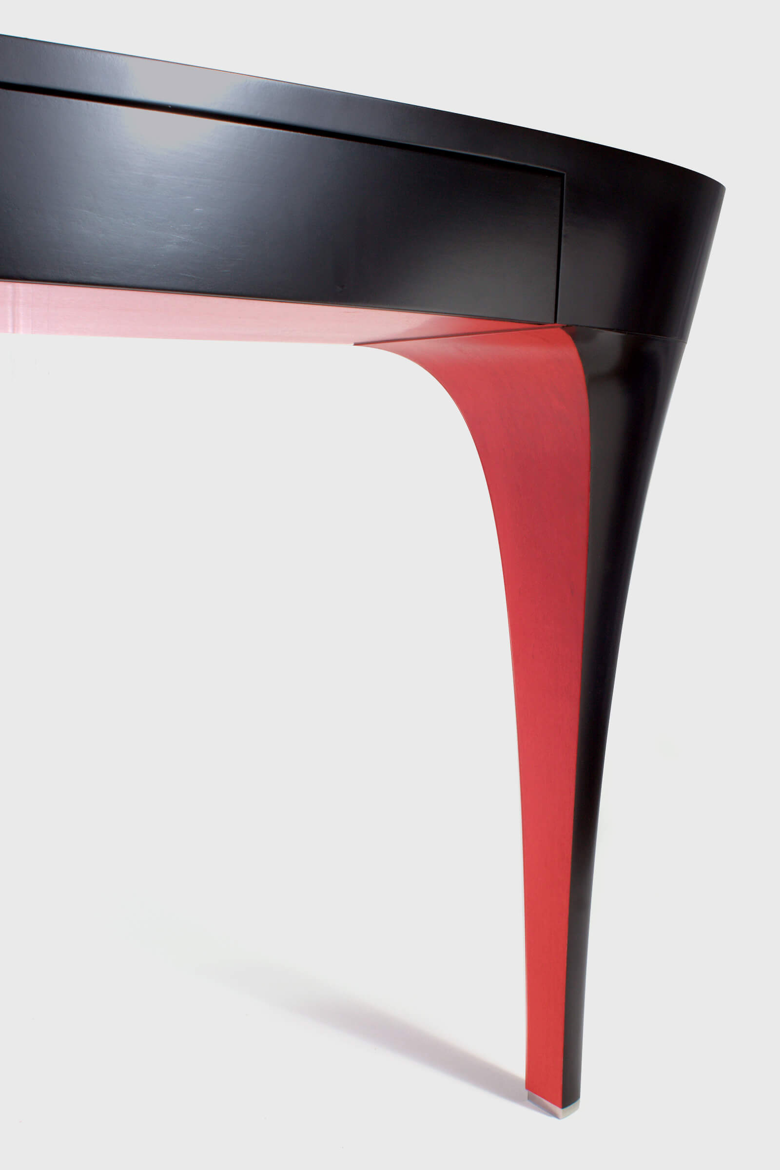 Luxurious black lacquer dressing table with red detail by Splinterworks.