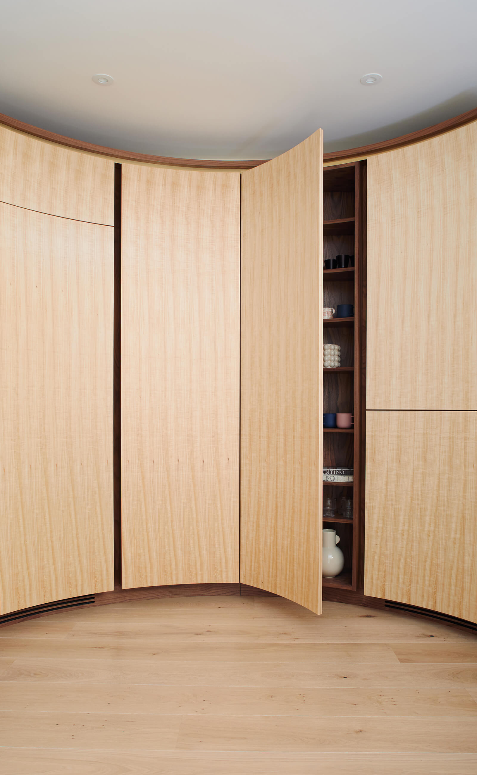 Thoughtful storage in contemporary circular kitchen designed by Splinterworks