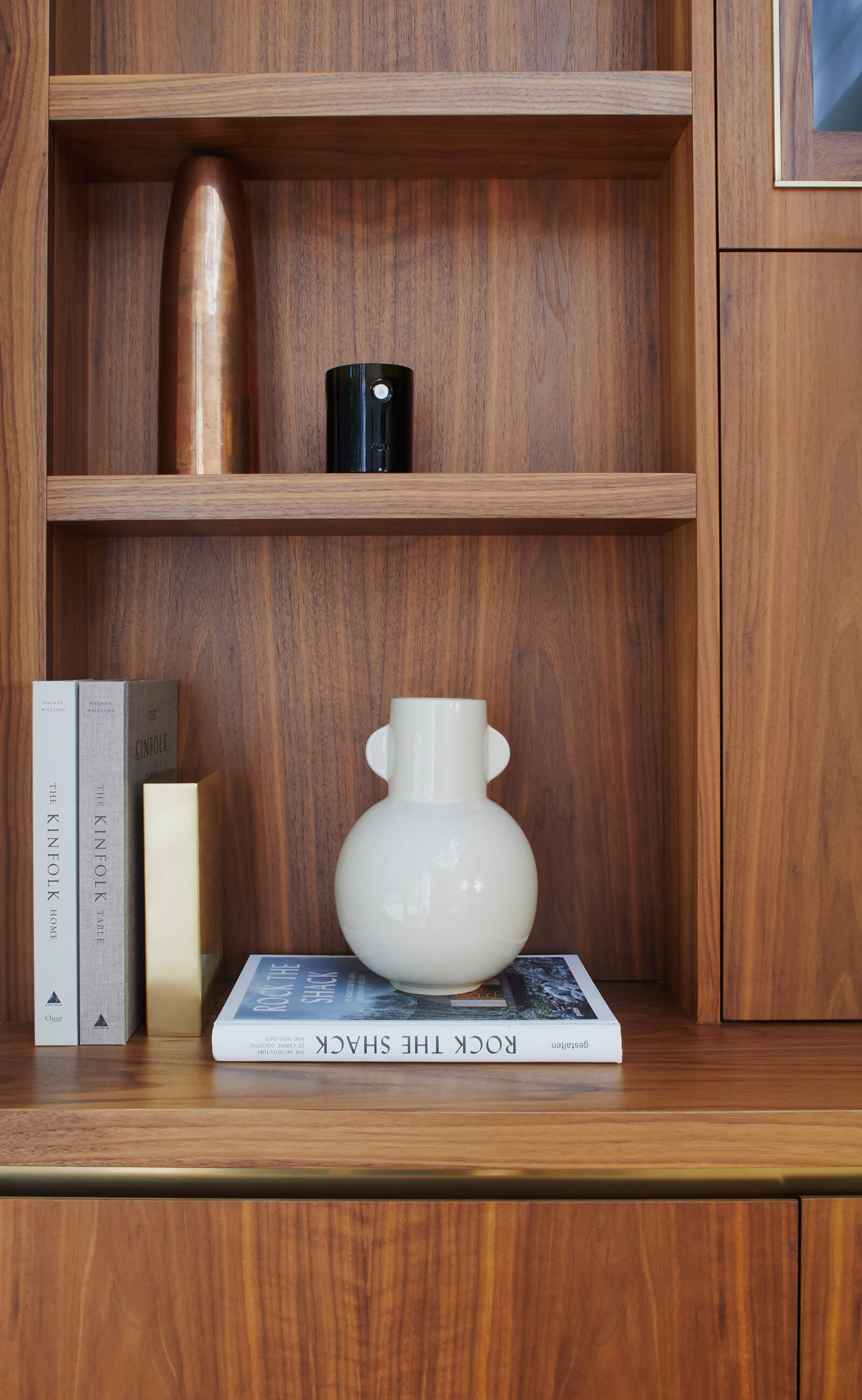 Bespoke walnut cabinetry with brass detail by Splinterworks