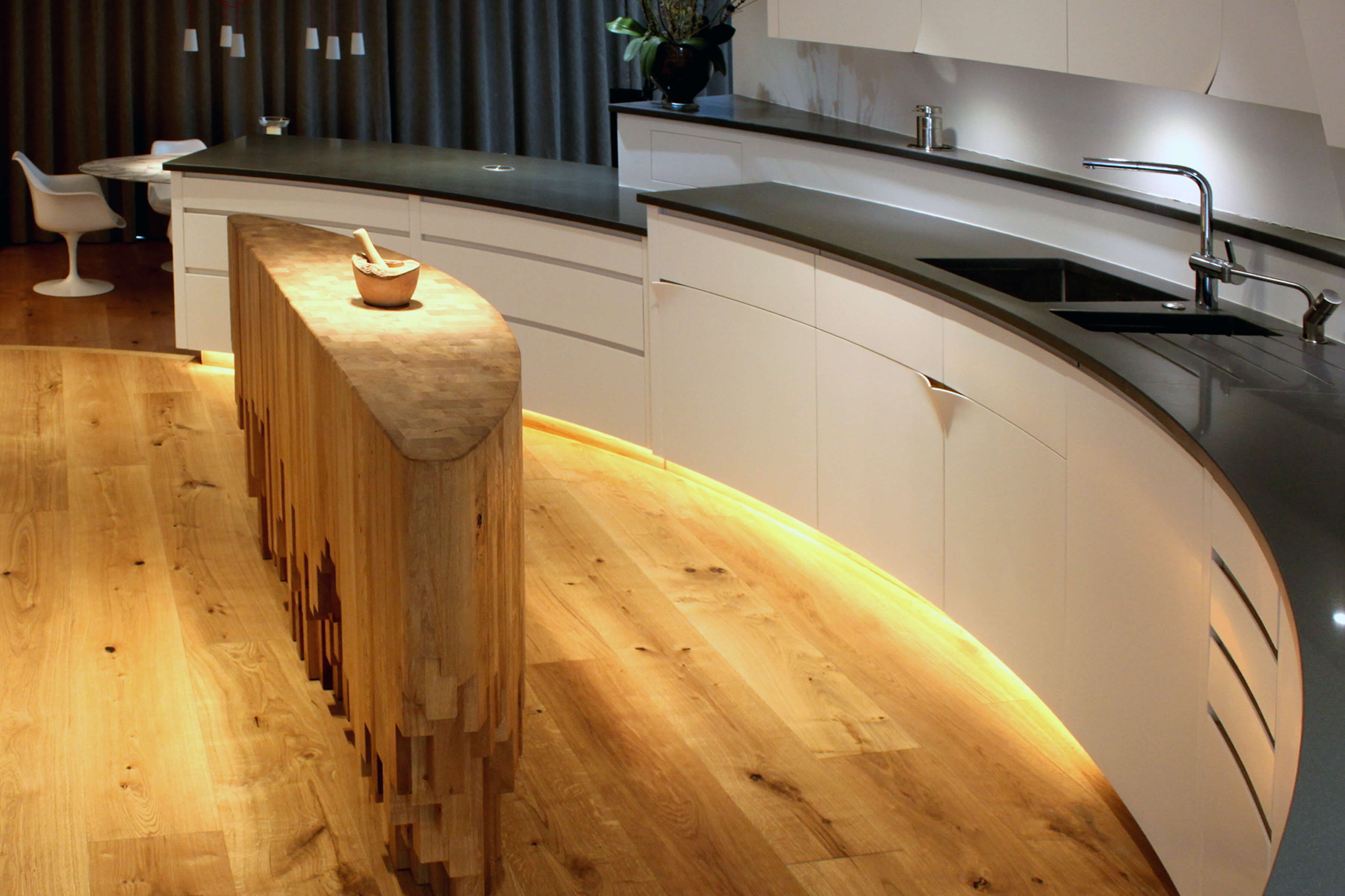 Curved kitchen designed by Splinterworks with a sculptural kitchen island