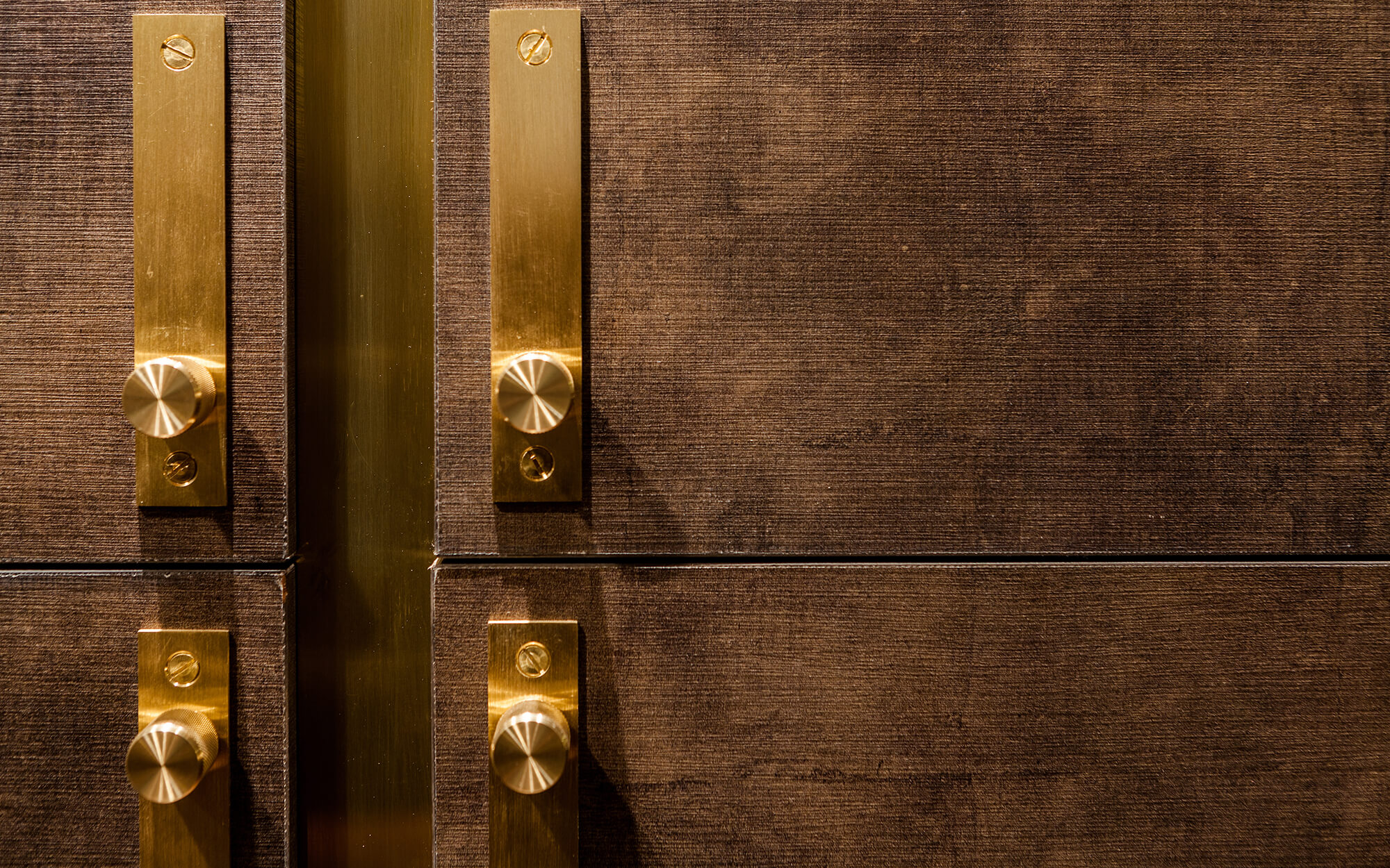 Brass trim on dark brown kitchen cabinetry custom built by Splinterworks