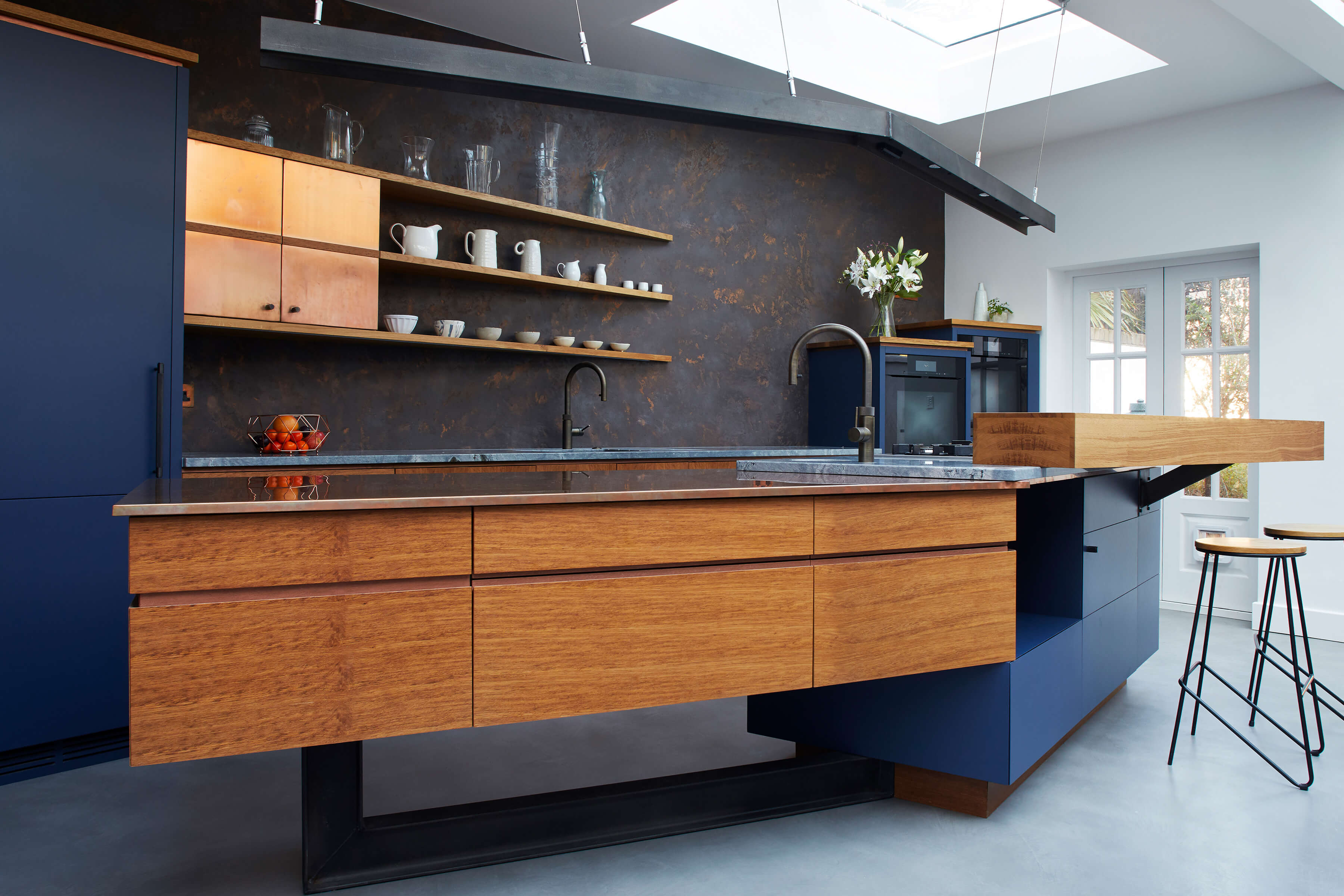 Blue and copper metal kitchen with clever storage and ergonomic design