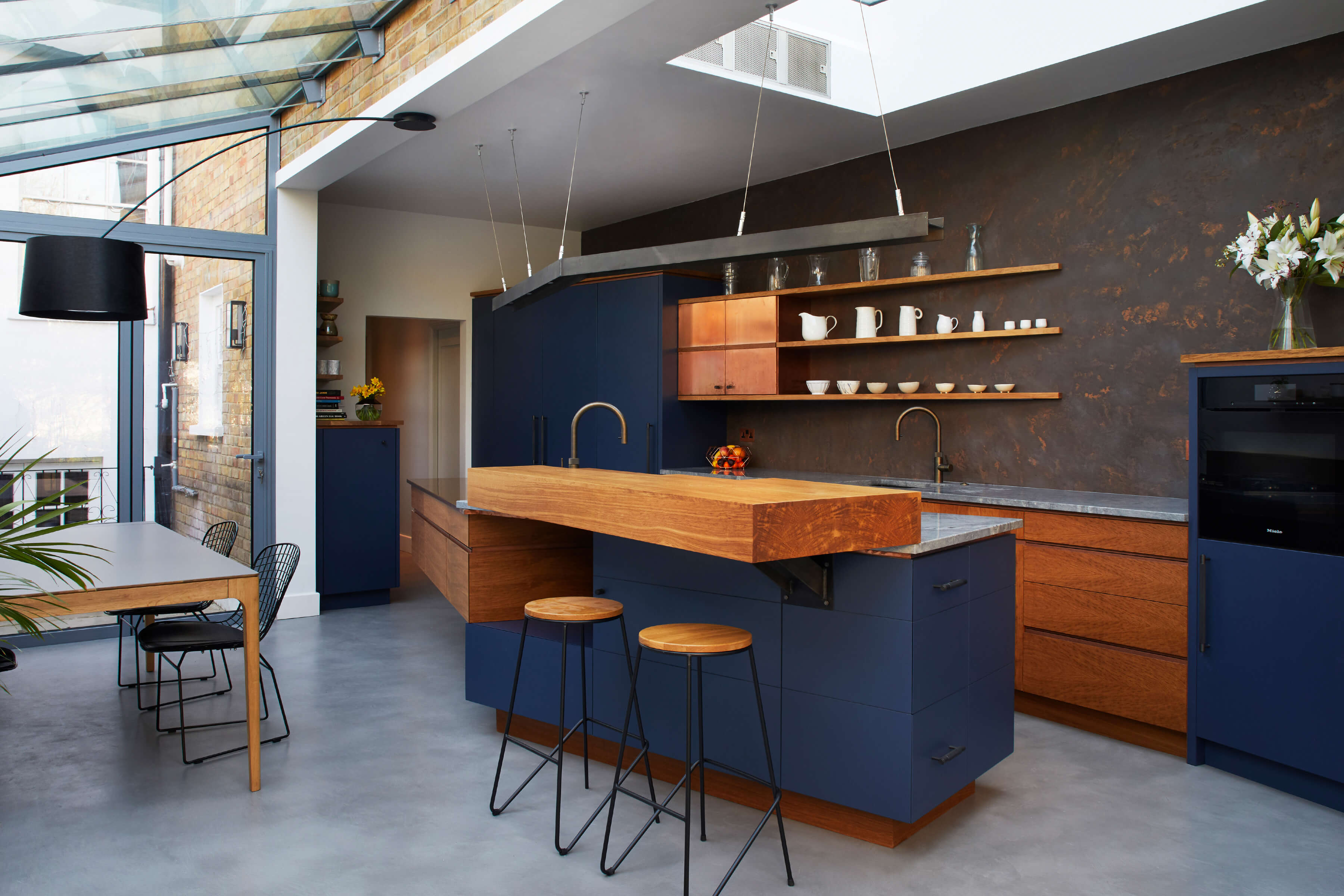 A fun family kitchen in London townhouse designed with copper and concrete details