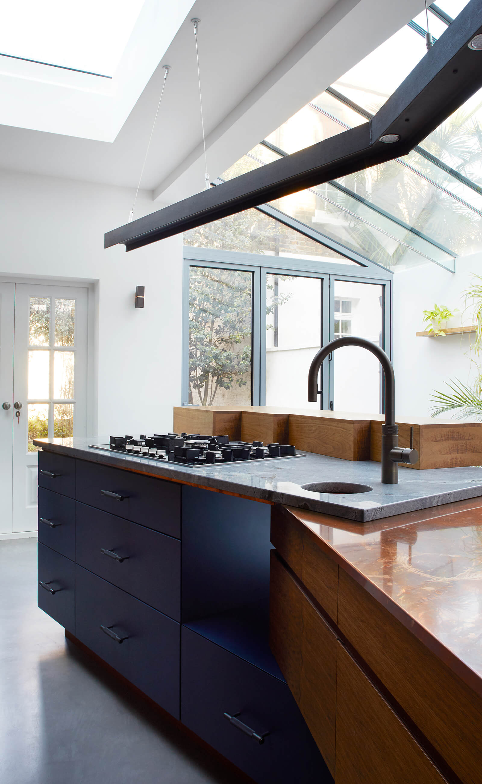 Concrete and copper work surfaces in family townhouse kitchen designed by Splinterworks