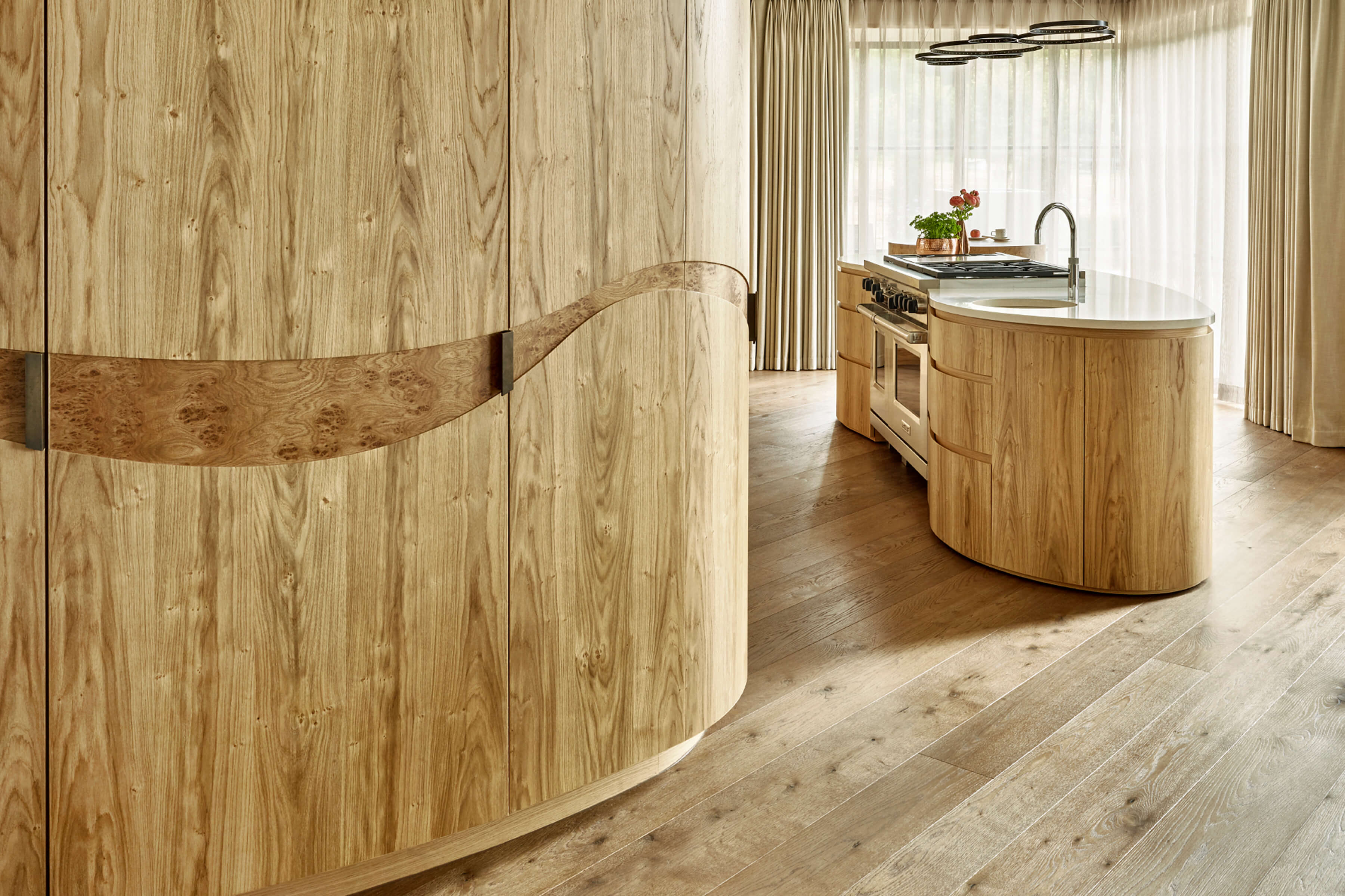 Custom made curved kitchen cabinetry in natural woods