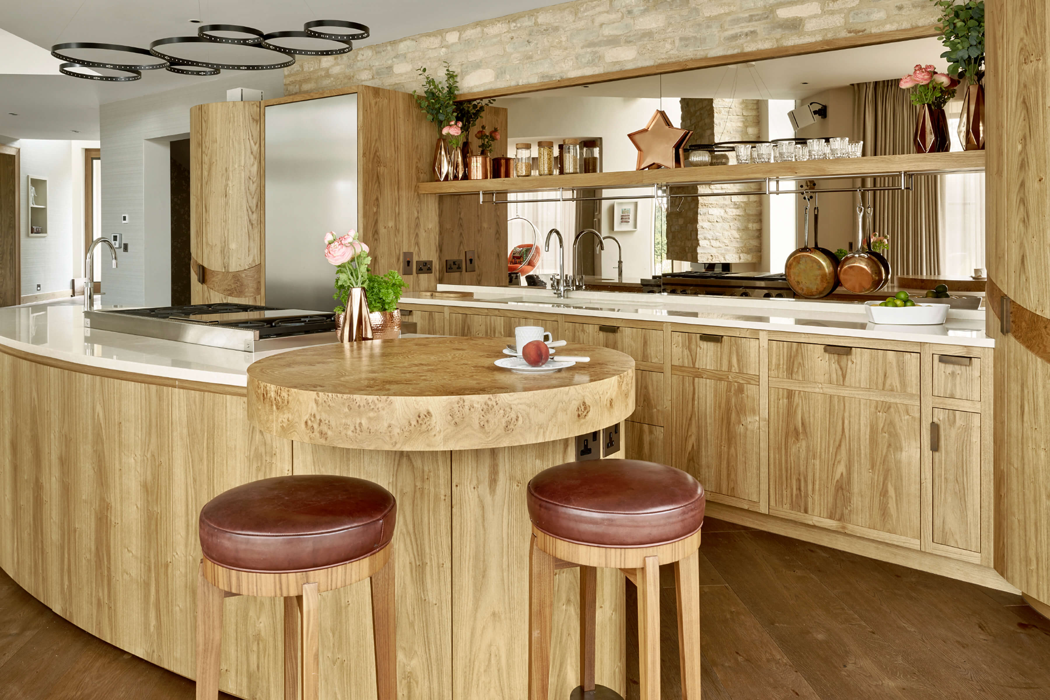 Contemporary oak kitchen with curved cabinetry by Splinterworks