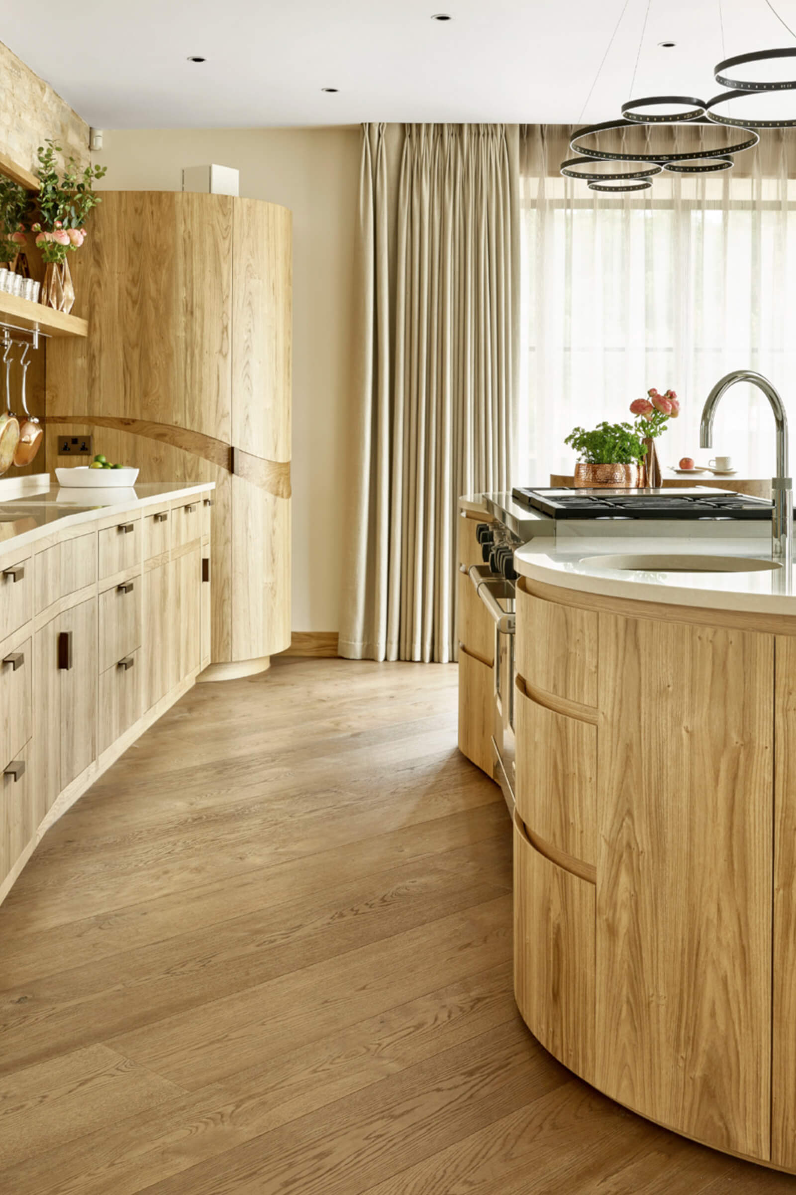 contemporary kitchen in natural oak with curved cabinetry