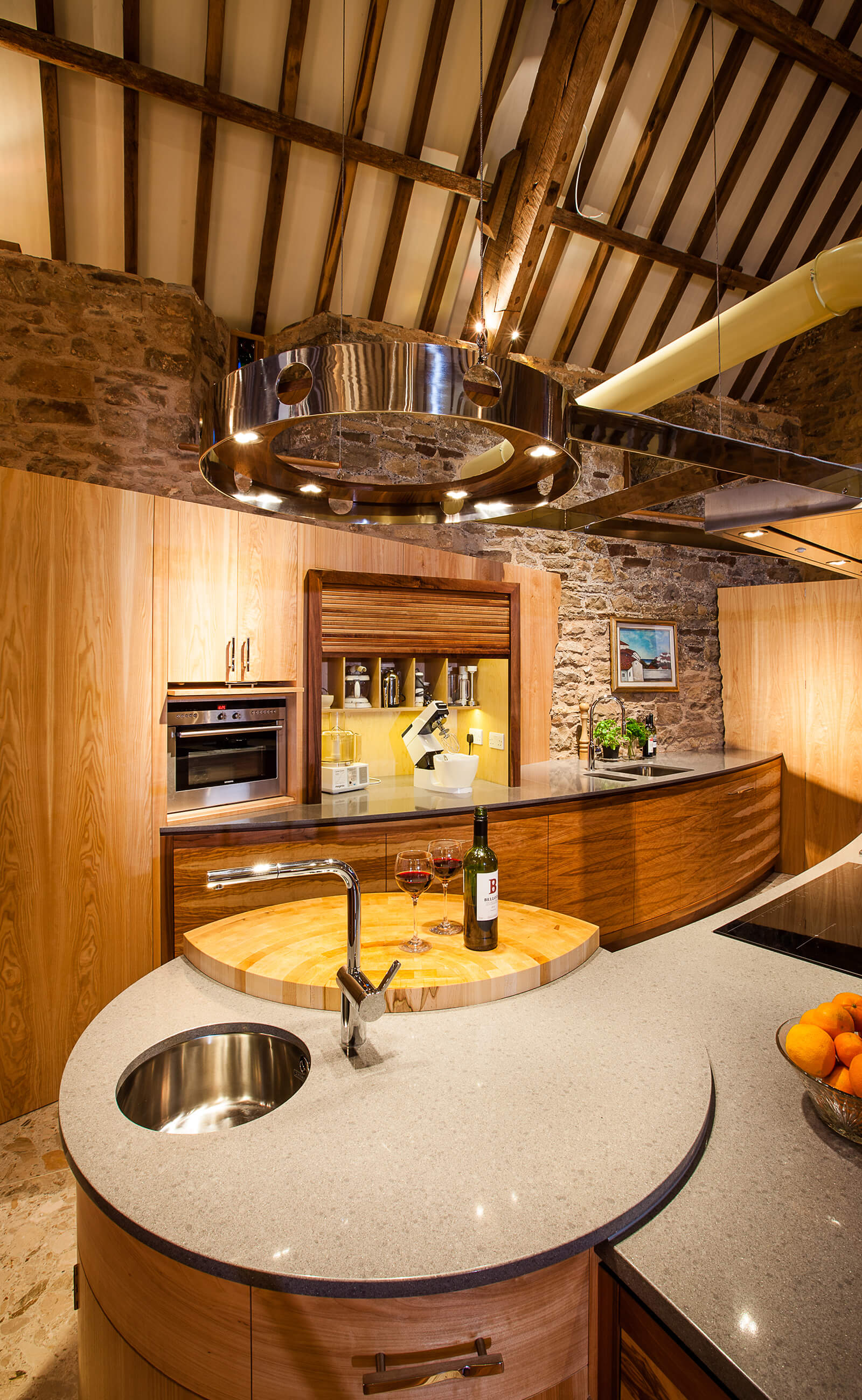 Curved kitchen design in barn restoration