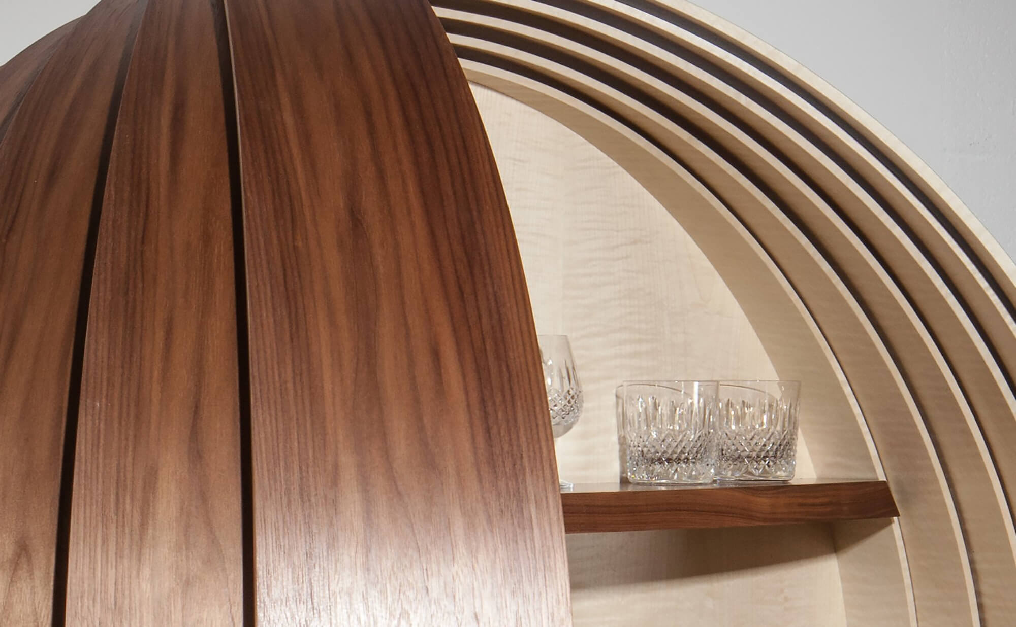 Detail of the luxury Dime bespoke drinks cabinet with crystal glasses on shelf.