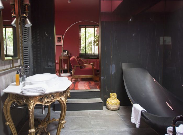 Suspended carbon fibre bath in black hotel room in Hotel Staats, Amsterdam