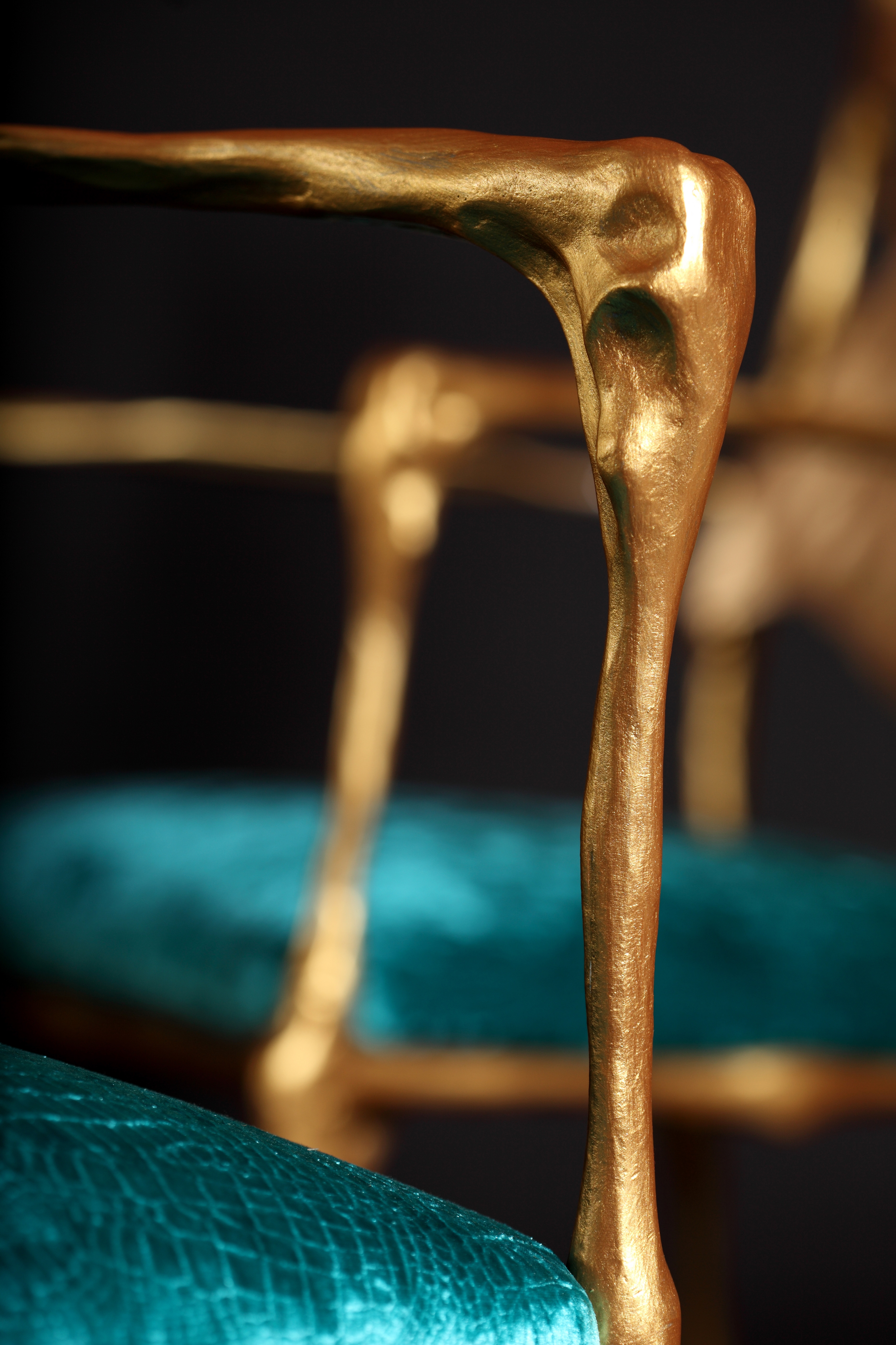 Dali-esq chair with hand sculpted arms in bronze and velvet teal cushion