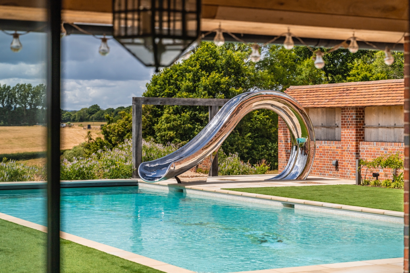 Side view of a waha water slide, with English countryside behind