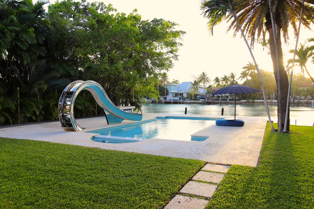 Waha pool slide in Floridan back garden by the water