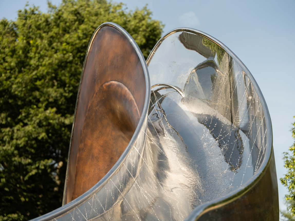 Close up of shoots of water on the inside of stainless steel pool slide