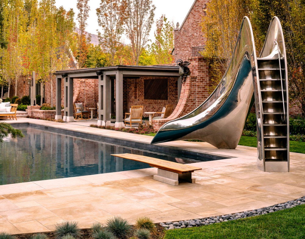 Stainless Steel Vertex Slide next to a diving board and cabana