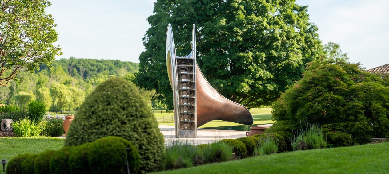 Bronze Vertex water slide taken from behind surrounded by trees