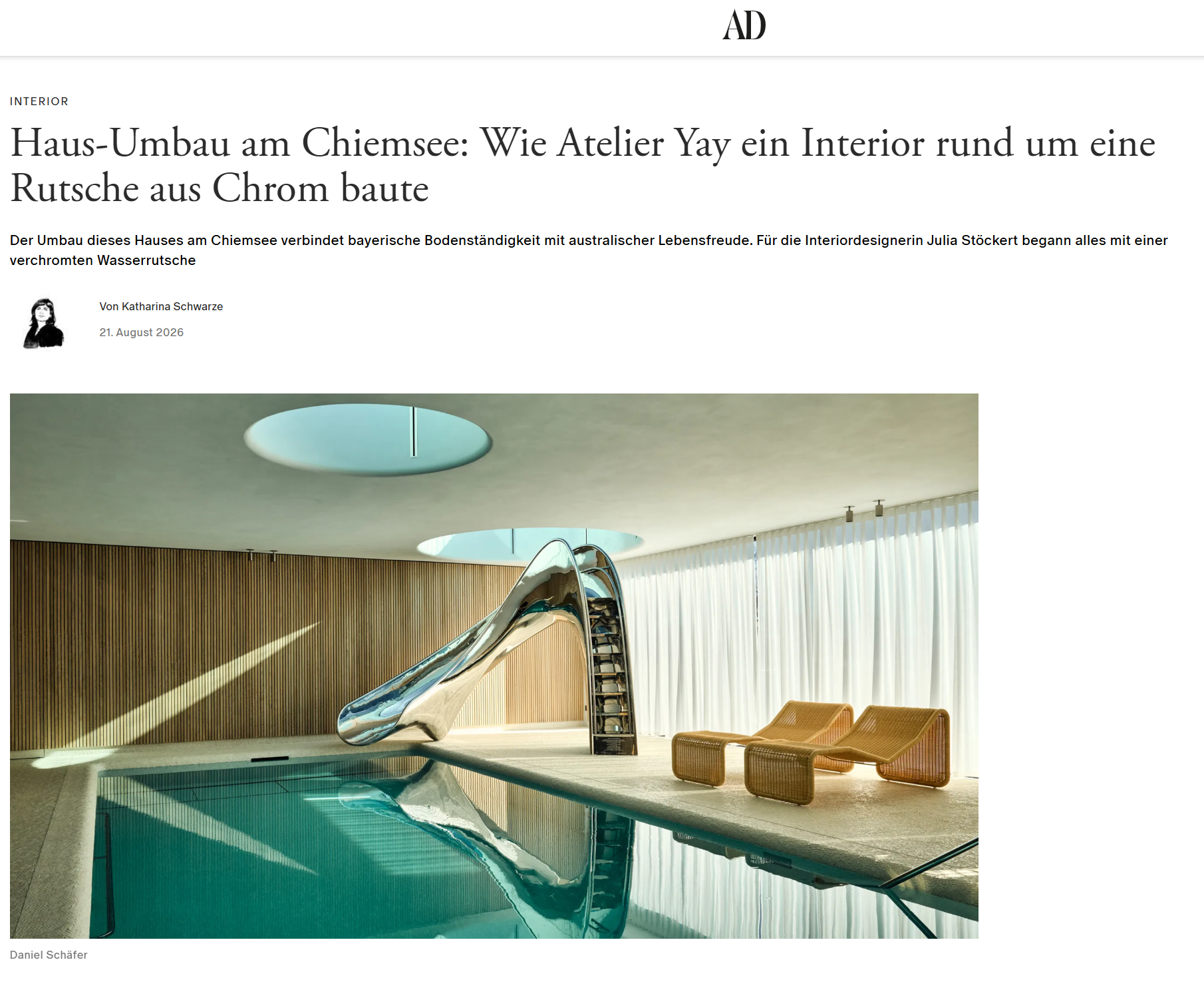 Custom indoor chrome slide leading into a pool at a modern Lake Chiemsee home designed by Atelier Yay